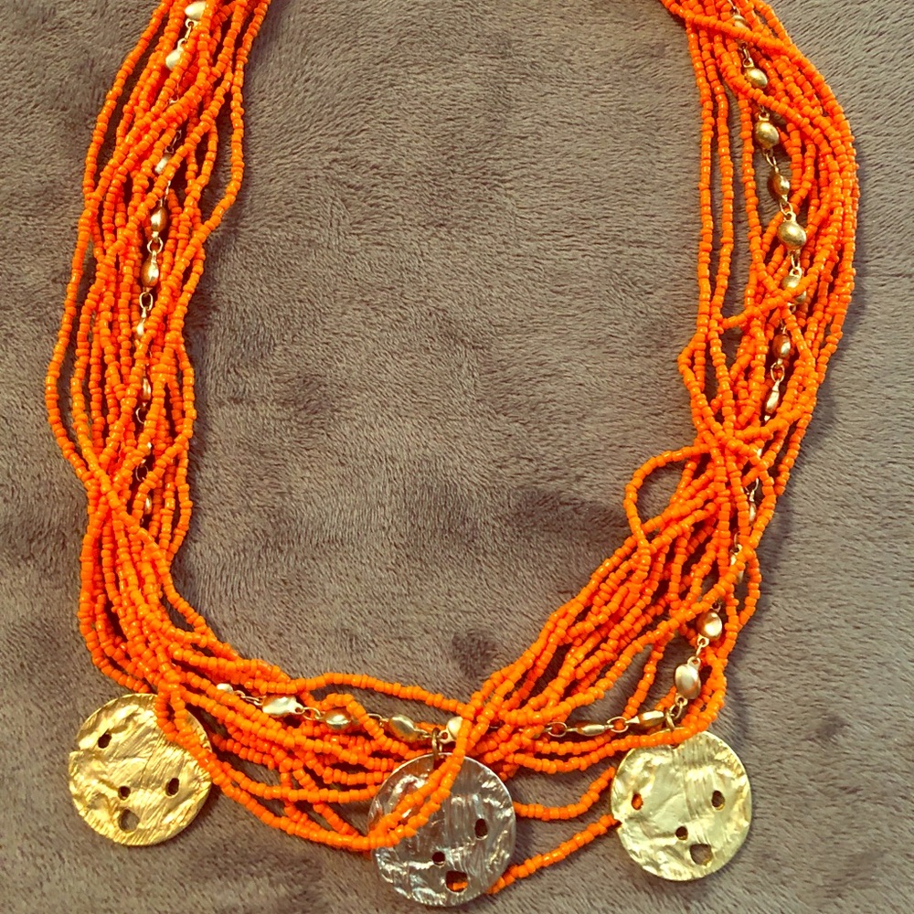 Orange beaded necklace with gold charm pendants